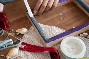 high-angle-child-decorating-wooden-frame-min